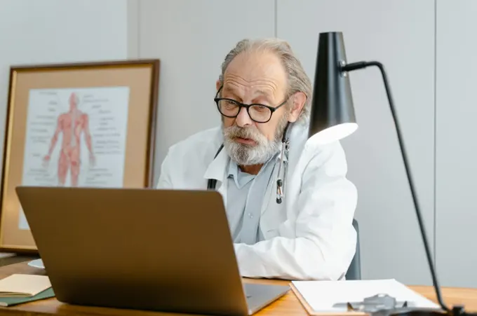 Doctor doing some research on laptop