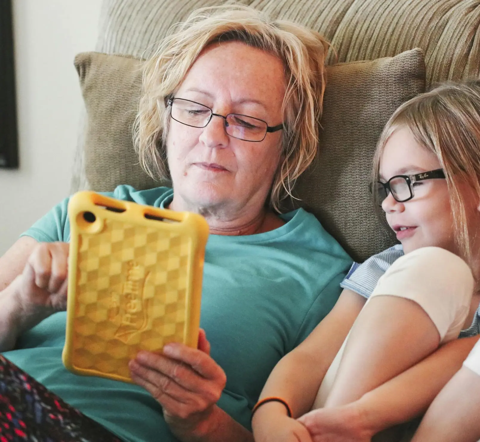 A woman playing video game with her daughter