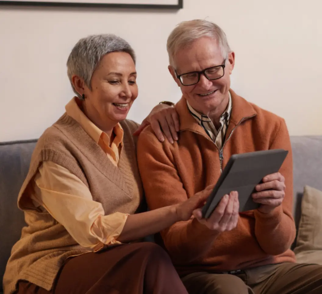 A man a woman seeing something on tablet